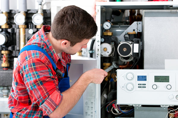Heating technician repairing boiler controls in Santa Clara