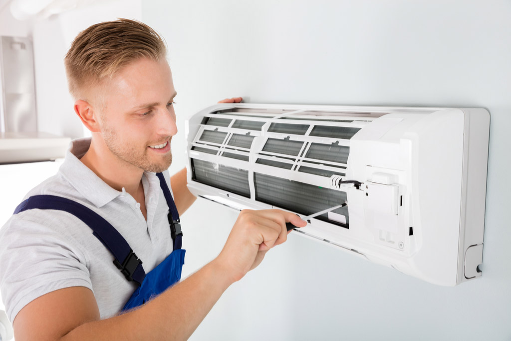 HVAC technician maintaining a ductless air conditioner in Santa Clara