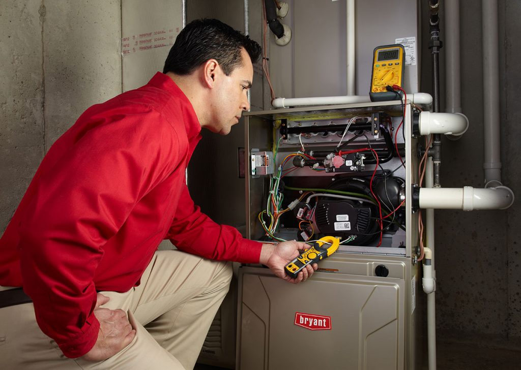 Heating technician diagnosing a furnace repair in Santa Clara
