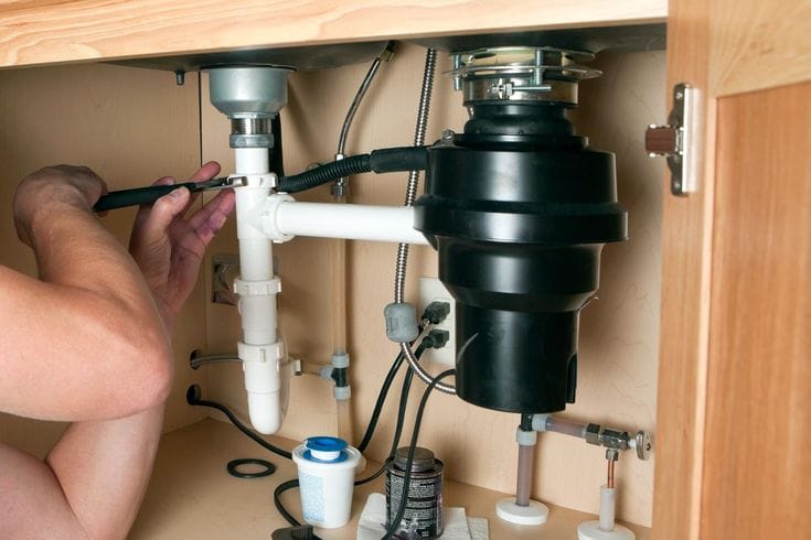 Plumber repairing a garbage disposal in Santa Clara