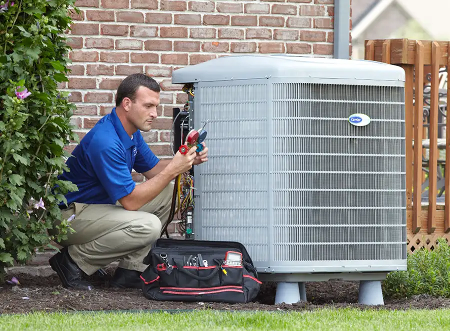 HVAC technician inspecting an outdoor AC unit in Santa Clara